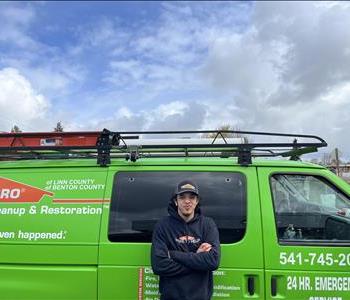 Young man with black hoody and servpro van