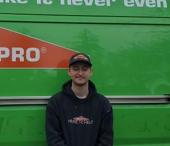 Young man with black hoody and servpro van